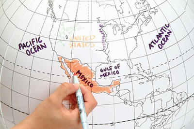 Inflatable globe with place names written in wet-erase marker