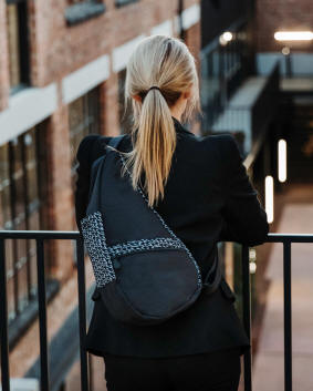 Ameribag healthy back bag jagged plaid white and black worn by a young woman