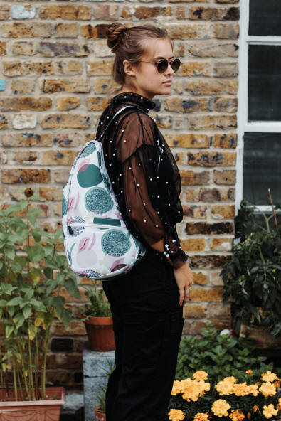 Ameribag healthy back bag in Fig patterns worn by young woman