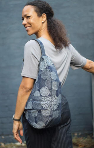  Flower Power Healthy Back Bag worn by a smiling woman