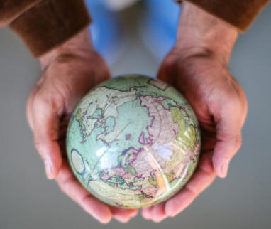 MOVA solar powered green globe held cradled in hands