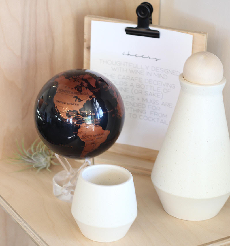 copper black solar power world globe on shelf