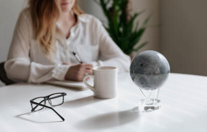 Moon solar powered revolving globe on table