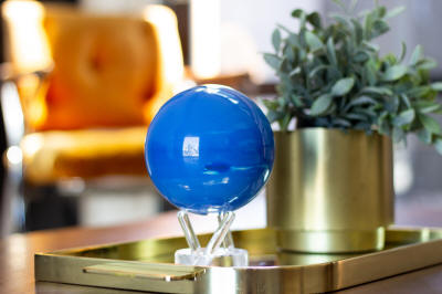 Neptune solar powered rotating globe on table