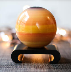 Saturn solar powered rotating globe on arch base