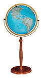 Large illuminated blue oceans world globe on pedestal